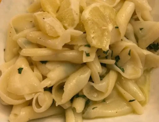 Arricciati pasta with lemon, olive oil and mint on a ceramic dish