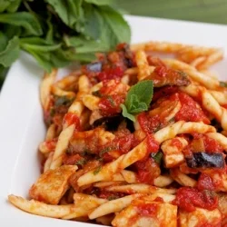 Busiate with swordfish and aubergines served on a Sicilian ceramic plate