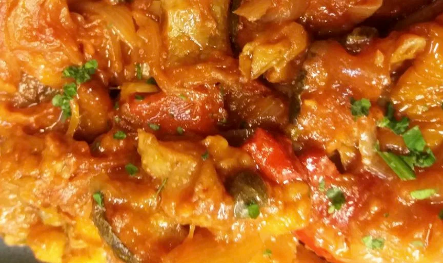 Apple caponata with olives and celery in a Sicilian ceramic bowl