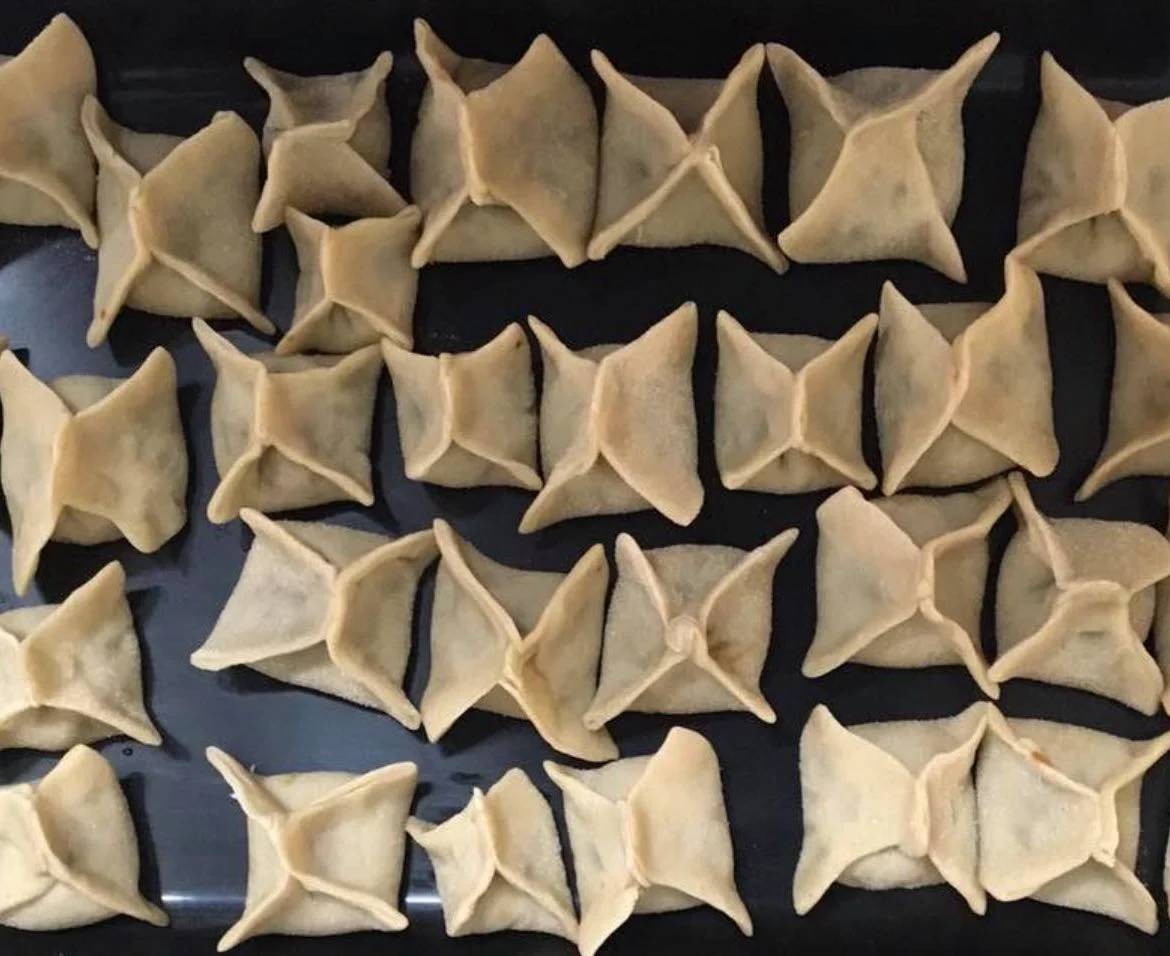 Priest’s Caps from Scicli served on a rustic plate with grape must and toasted almonds