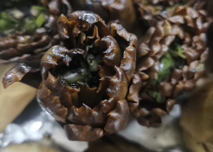 Sicilian fire-roasted artichokes on a grill