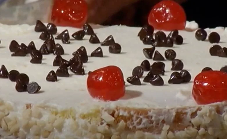 Siracusan cassata decorated with candied fruit, pistachio and almond crumbs on a Sicilian ceramic tray