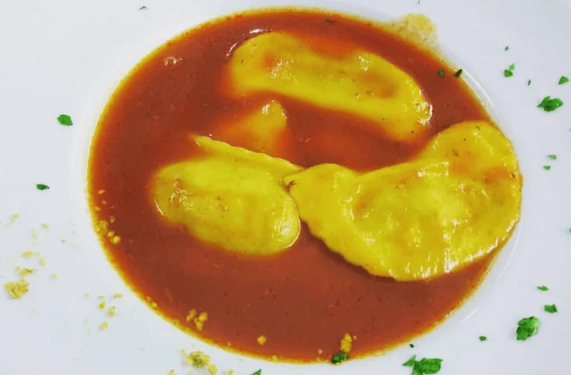 Ricotta cassatelle served in a delicate fish broth