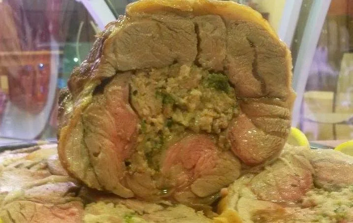 Stuffed Sicilian kid leg with herbs and cheese, roasted until golden