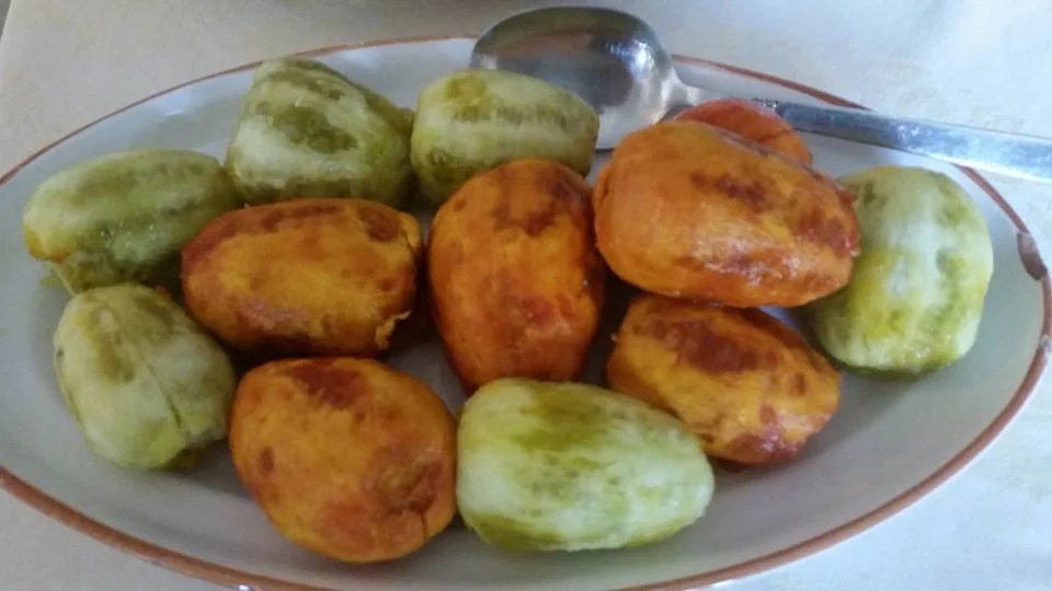Sicilian prickly pear jam in a glass jar with fresh fruit in the background