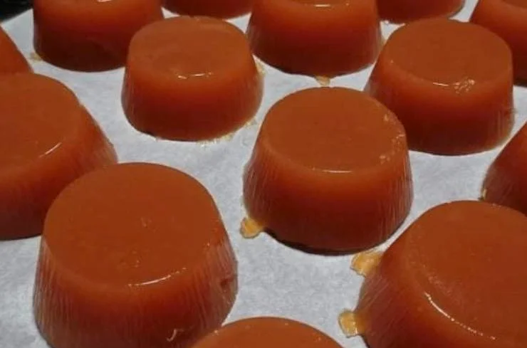 Golden Sicilian quince paste cubes served on a decorated ceramic plate