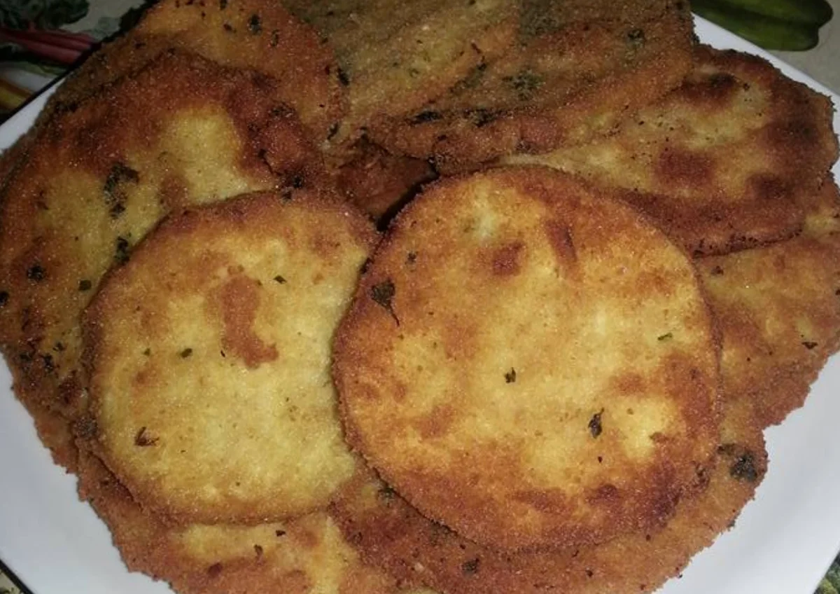Golden, crisp Sicilian aubergine cutlets served on a decorated ceramic plate