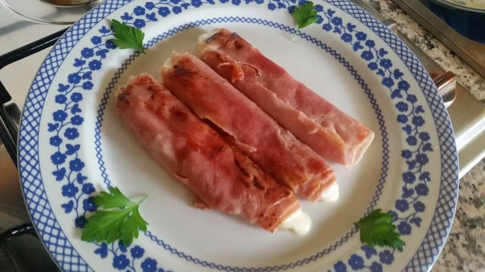 Ham and caciocavallo roll-ups on a traditional Sicilian ceramic plate