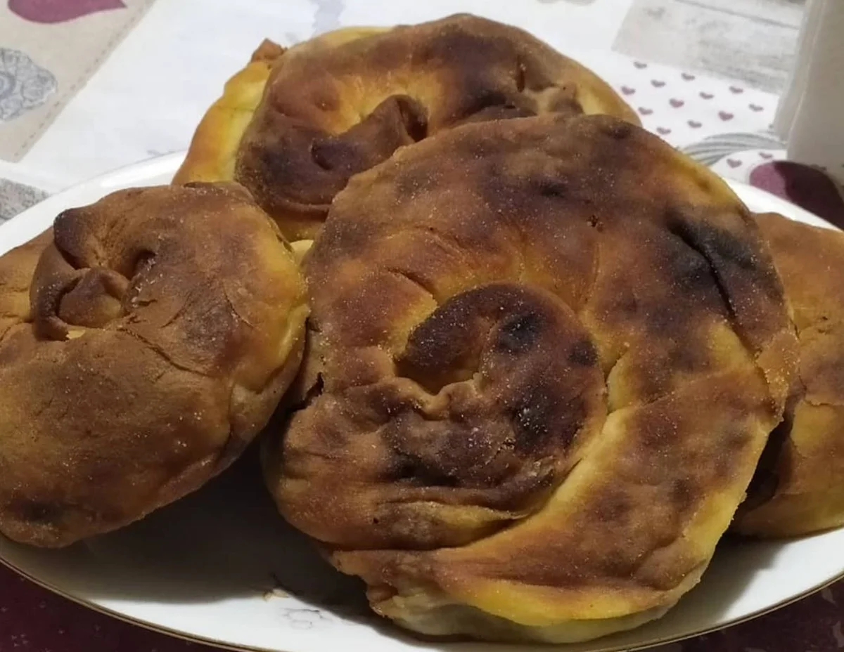 Golden Sicilian mpignulata with a savoury pork, onion and olive filling