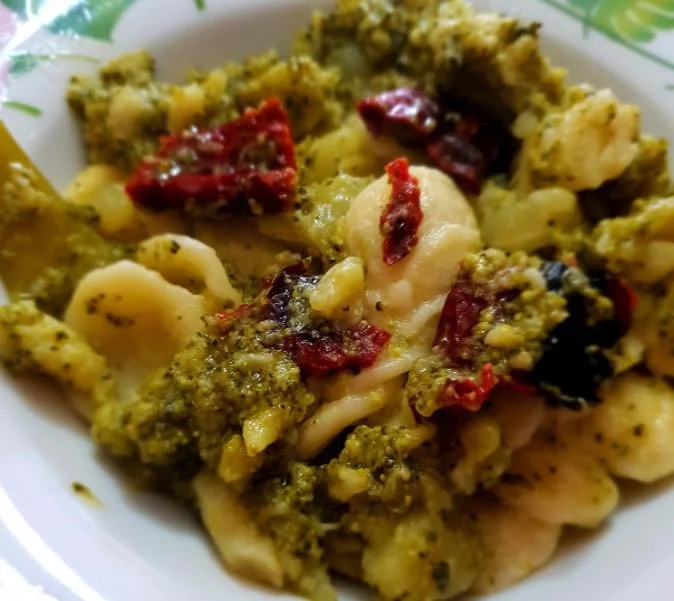 A bowl of pasta with broccoli and potatoes