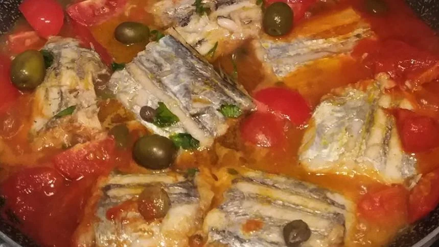 Silver scabbardfish Messina-style served with cherry tomatoes, olives and capers